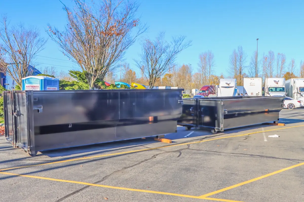 Professional dumpster rental service with roll-off container on residential driveway in Braidwood